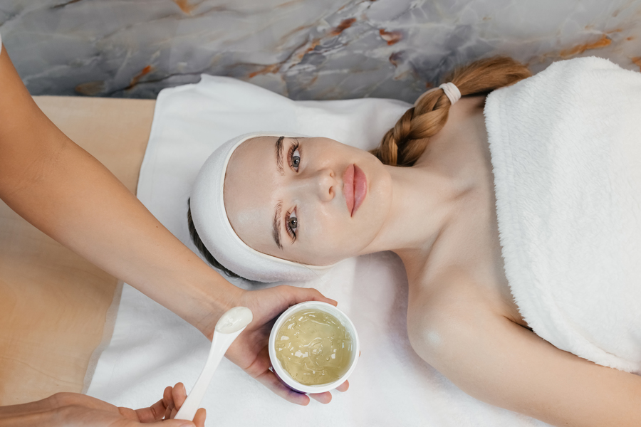 Close-up portrait of woman getting spa facial massage treatment