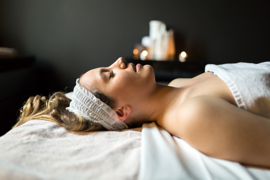 Beautiful woman lying on massage table